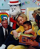 Hillary Clinton reads a book to an African-American grade-schooler in Maryland during Read Across America Day in 1998