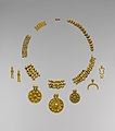 Perles en or formant un collier et pendentifs symbolisant des divinités trouvés dans le « trésor de Dilbat », milieu du IIe millénaire av. J.-C. Metropolitan Museum of Art.
