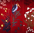 Trois panneaux rouges formant un carré peint de fleurs et de feuilles avec au milieu des grenouilles et un gros oiseau à long bec.