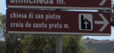 Panneau avec signalisation locale bilingue en italien et en sarde.