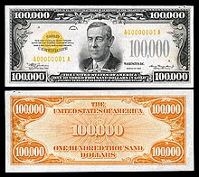 Billet de 100,000 $US où on peut voir en arrière-plan le symbole « dollar » avec deux barres au lieu d’une.