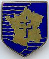 Insigne de la 2e division blindée fabriqué en Angleterre avant son débarquement en Normandie. Cet emblème représente la France, avec en son centre la croix de Lorraine.
