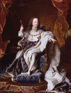 La tenue de sacre de Louis XV comporte de la fourrure précieuse (hermine), des fleurs de lys sur fond bleu. Il tient les attributs royaux : le sceptre et l'épée réservée à la noblesse.