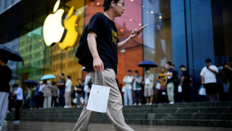 Un homme tient un sac contenant un iPhone neuf à Shanghai, en Chine, le 22 septembre 2023.
