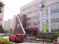 South Korean firefighters excercise drill/public training. A hydraulic platform stretchs up.